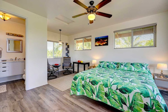 12-7036 Kaiwa St, Pahoa, HI 96778 - bedroom with wood finished floors, a sink, and attic access