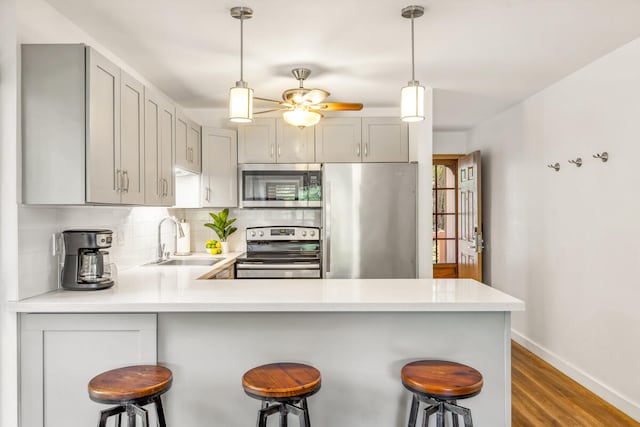 3411 Wilcox Rd Unit F 69, Lihue, HI 96766 - kitchen with appliances with stainless steel finishes, gray cabinetry, and light countertops