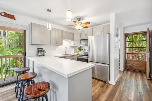 3411 Wilcox Rd Unit F 69, Lihue, HI 96766 - kitchen with appliances with stainless steel finishes, gray cabinetry, and healthy amount of natural light