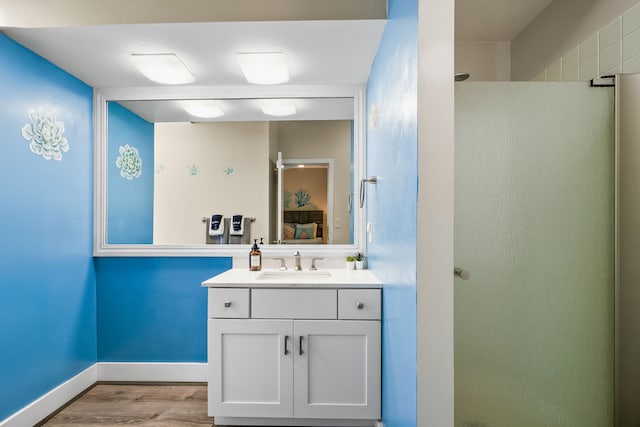 1565 Pee Rd Unit 225, Koloa, HI 96756 - bathroom featuring vanity, wood finished floors, walk in shower, and baseboards