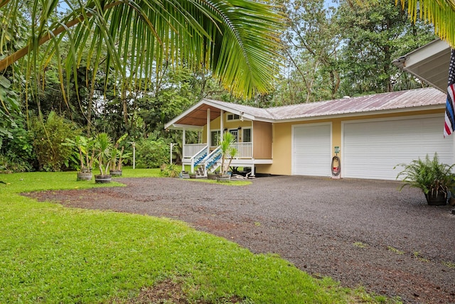 15-2693 Oio St, Pahoa, HI 96778 - view of front facade with a front lawn, driveway, a porch, and metal roof