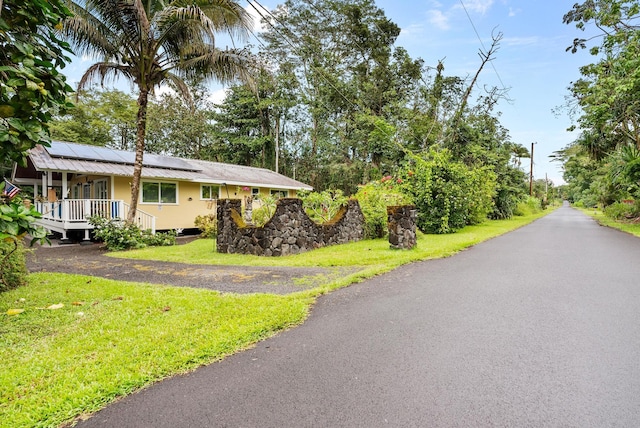 15-2693 Oio St, Pahoa, HI 96778 - view of front of home with roof mounted solar panels and a front lawn