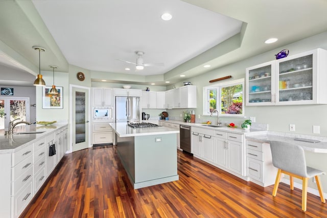 76-4391 Leilani St, Kailua-Kona, HI 96740 - kitchen featuring appliances with stainless steel finishes, a center island, dark wood-type flooring, glass insert cabinets, and recessed lighting