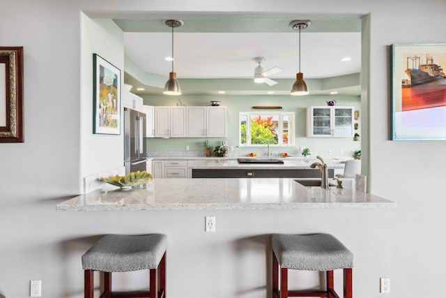76-4391 Leilani St, Kailua-Kona, HI 96740 - kitchen with high quality fridge, a breakfast bar area, a peninsula, pendant lighting, and recessed lighting