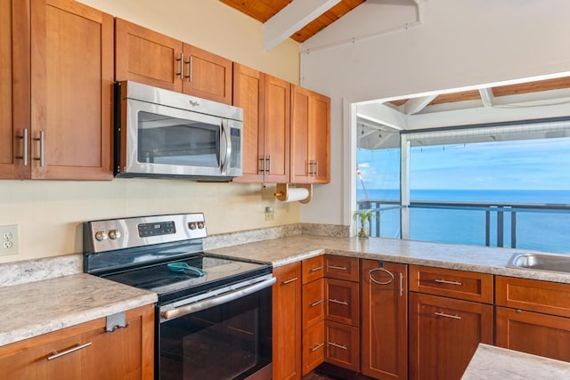 87-3181 Japonica Rd, Captain Cook, HI 96704 - kitchen featuring stainless steel appliances, beam ceiling, light countertops, and brown cabinets