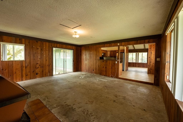 137 Kuakolu Pl, Hilo, HI 96720 - unfurnished living room with wooden walls and a textured ceiling