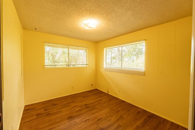 137 Kuakolu Pl, Hilo, HI 96720 - spare room with a textured ceiling and dark wood finished floors