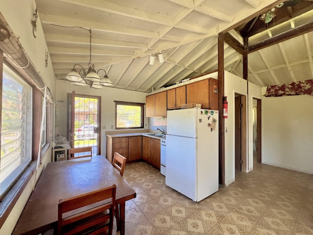 95-5974-A Mamalahoa Hwy, Naalehu, HI 96772 - kitchen with white appliances, brown cabinetry, a chandelier, and light flooring