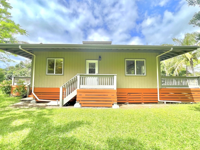 95-5974-A Mamalahoa Hwy, Naalehu, HI 96772 - rear view of property featuring a lawn and a deck