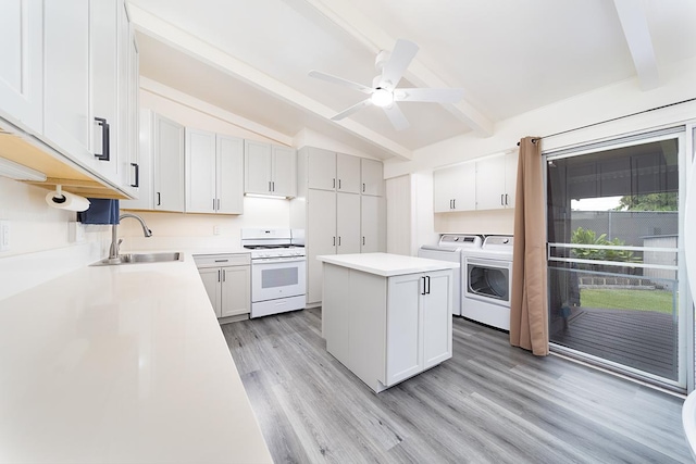 4 Nani Pl, Hilo, HI 96720 - kitchen with white gas range oven, washing machine and clothes dryer, a sink, light wood-type flooring, and a ceiling fan