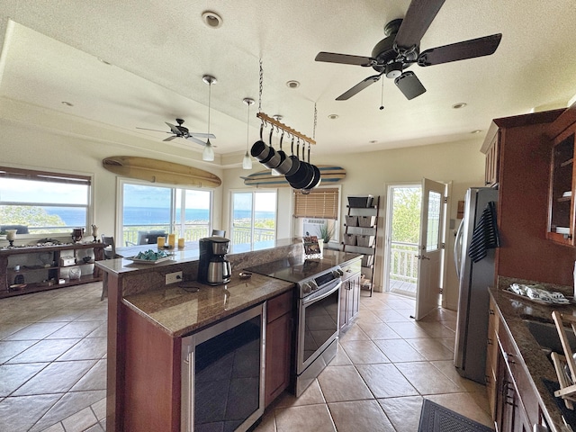 77-6450 Walua Rd, Kailua-Kona, HI 96740 - kitchen with appliances with stainless steel finishes, a ceiling fan, a center island, dark stone countertops, and light tile patterned floors