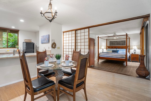 78-6800 Alii Dr Unit 8104, Kailua-Kona, HI 96740 - dining area with light wood-style flooring, a textured ceiling, a ceiling fan, recessed lighting, and a chandelier