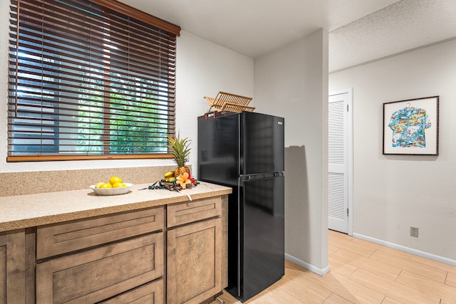 78-6800 Alii Dr Unit 8104, Kailua-Kona, HI 96740 - kitchen featuring freestanding refrigerator and light wood-style flooring