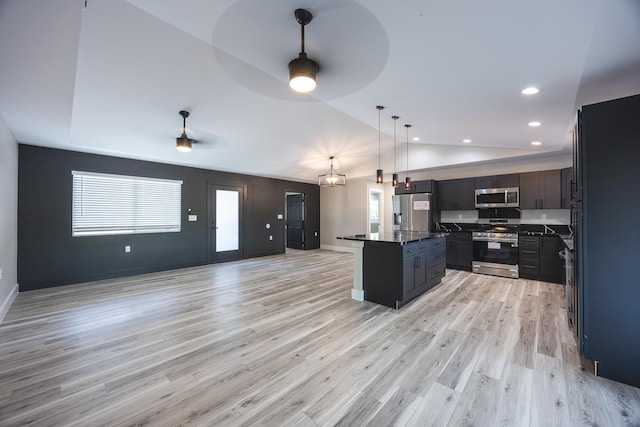 15-1776 6th Ave, Keaau, HI 96749 - kitchen featuring stainless steel appliances, dark countertops, open floor plan, vaulted ceiling, and plenty of natural light