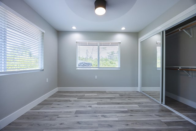 15-1776 6th Ave, Keaau, HI 96749 - unfurnished bedroom with multiple windows, a closet, wood finished floors, recessed lighting, and a ceiling fan