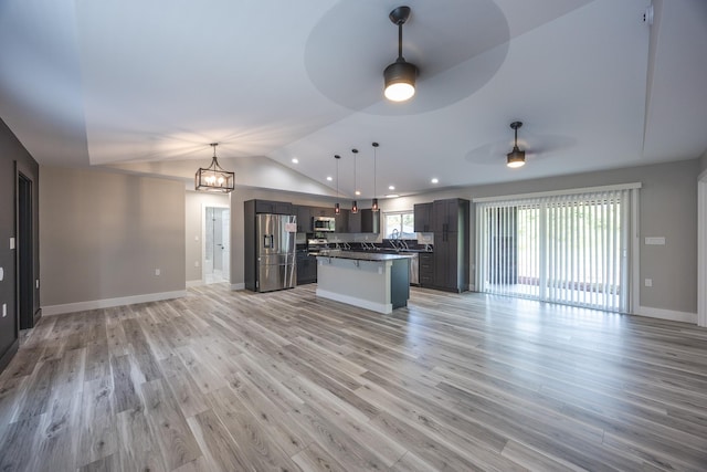 15-1776 6th Ave, Keaau, HI 96749 - unfurnished living room featuring a ceiling fan, vaulted ceiling, light wood-style flooring, baseboards, and recessed lighting