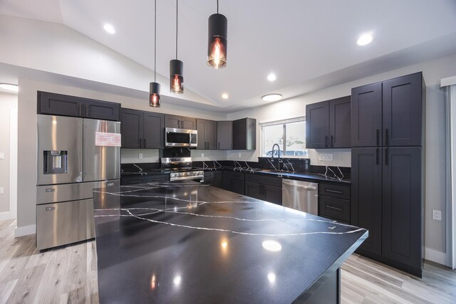 15-1776 6th Ave, Keaau, HI 96749 - kitchen with appliances with stainless steel finishes, dark countertops, lofted ceiling, a sink, and light wood-type flooring