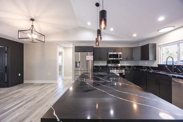 15-1776 6th Ave, Keaau, HI 96749 - kitchen with appliances with stainless steel finishes, a sink, dark countertops, vaulted ceiling, and light wood-style floors
