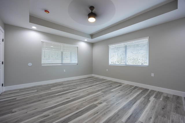 15-1776 6th Ave, Keaau, HI 96749 - empty room featuring light wood-type flooring, a ceiling fan, baseboards, a tray ceiling, and recessed lighting