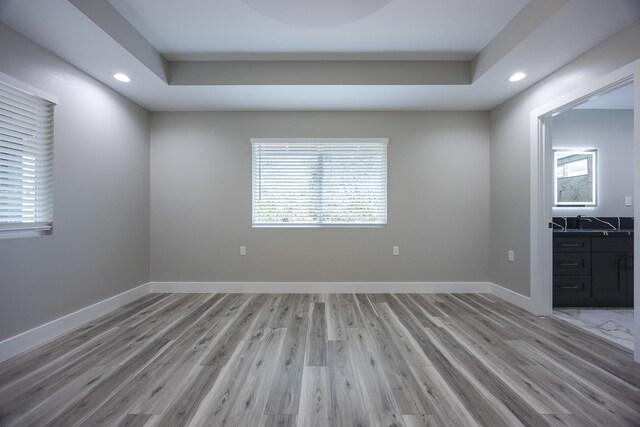 15-1776 6th Ave, Keaau, HI 96749 - empty room with light wood-style flooring, recessed lighting, baseboards, and a tray ceiling
