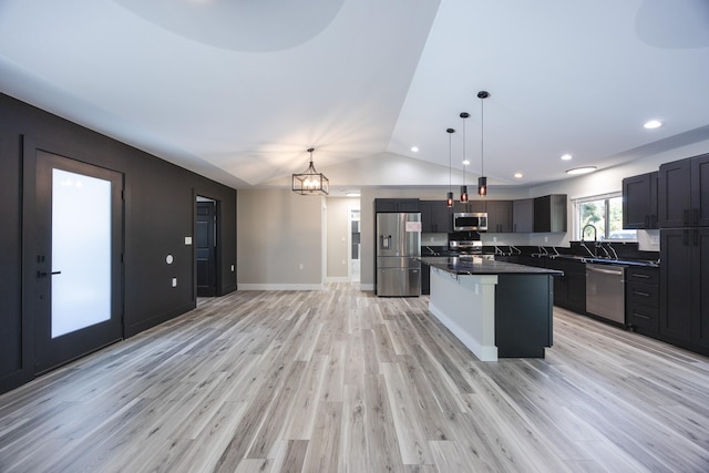 15-1776 6th Ave, Keaau, HI 96749 - kitchen with appliances with stainless steel finishes, lofted ceiling, dark countertops, light wood-style floors, and a center island