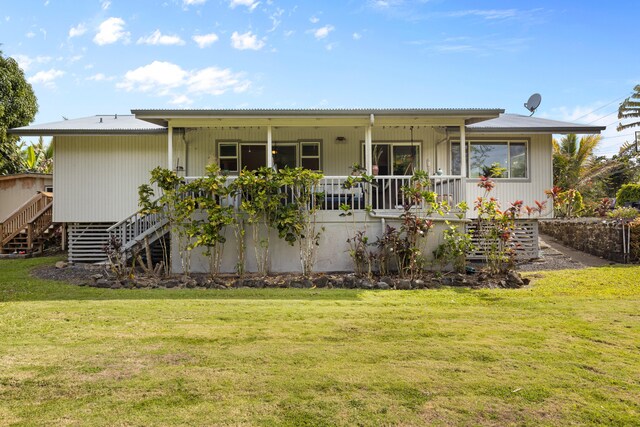 15-1385 Makuu Dr, Keaau, HI 96749 - back of house featuring stairs, a lawn, covered porch, and metal roof