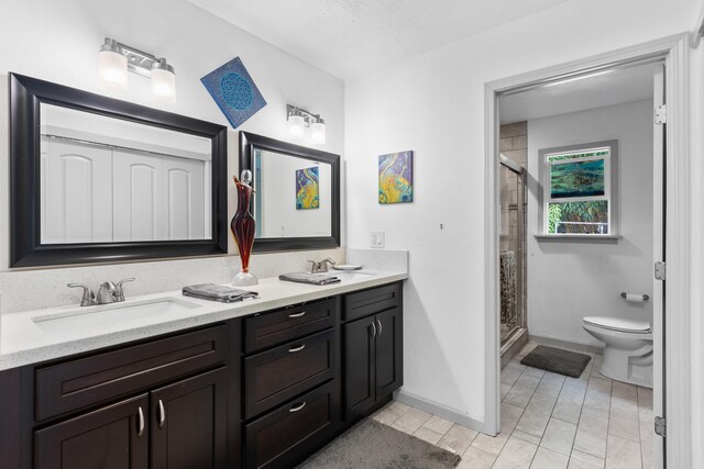 15-1385 Makuu Dr, Keaau, HI 96749 - bathroom with a stall shower, double vanity, toilet, and baseboards