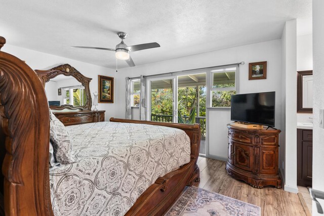 15-1385 Makuu Dr, Keaau, HI 96749 - bedroom featuring light wood-style floors, ceiling fan, and a textured ceiling