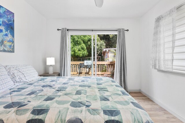 15-1385 Makuu Dr, Keaau, HI 96749 - bedroom with access to exterior, wood finished floors, baseboards, and ceiling fan
