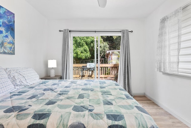 15-1385 Makuu Dr, Keaau, HI 96749 - bedroom with access to outside, wood finished floors, baseboards, and a ceiling fan