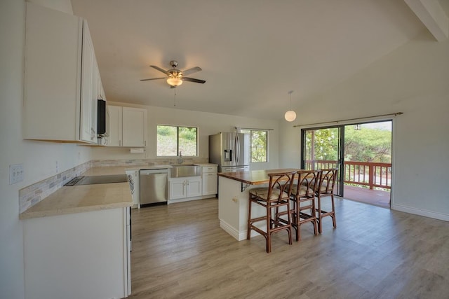 68-1780 Puu Nui St, Waikoloa, HI 96738 - kitchen with stainless steel appliances, a kitchen breakfast bar, light wood finished floors, white cabinetry, and high vaulted ceiling
