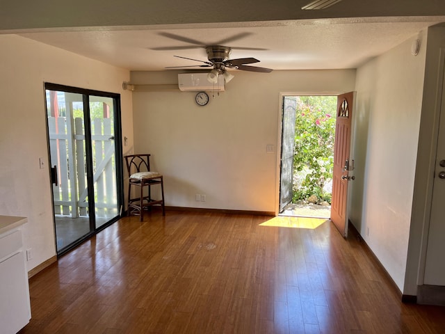 68-1780 Puu Nui St, Waikoloa, HI 96738 - spare room featuring dark wood-type flooring, a ceiling fan, and an AC wall unit