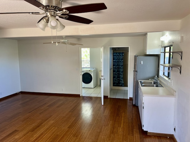 68-1780 Puu Nui St, Waikoloa, HI 96738 - kitchen featuring washer / dryer, wood finished floors, light countertops, a ceiling fan, and freestanding refrigerator