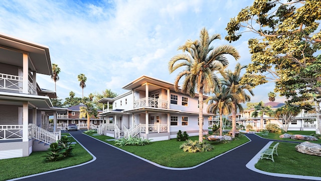 5460 Koloa Rd, Koloa, HI 96756 - view of front facade with a balcony, a front lawn, and covered porch