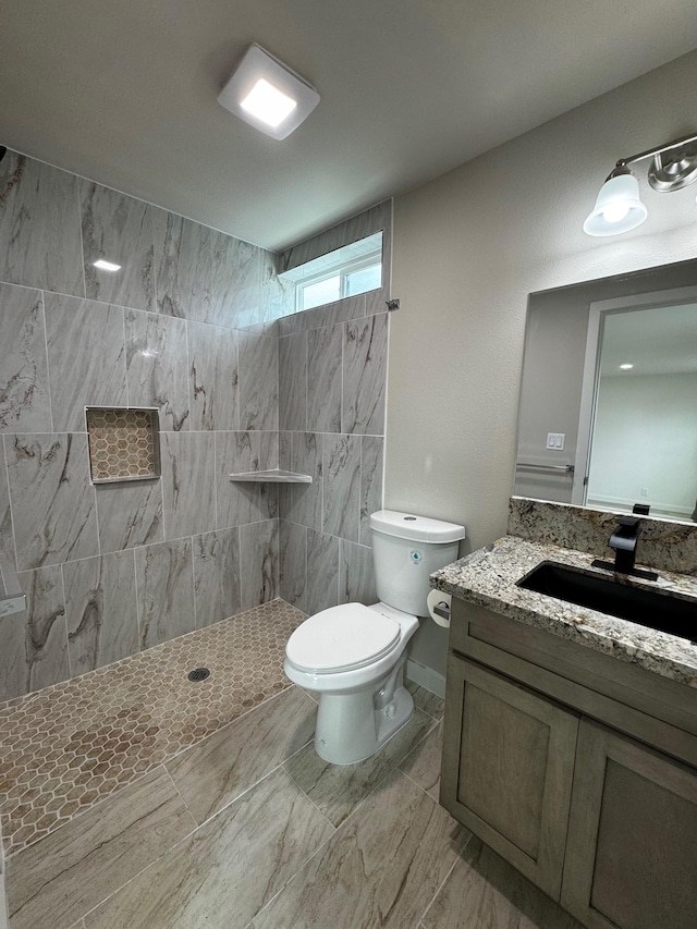16-2045 Hanale Dr, Pahoa, HI 96778 - bathroom featuring a tile shower, vanity, toilet, and marble finish flooring