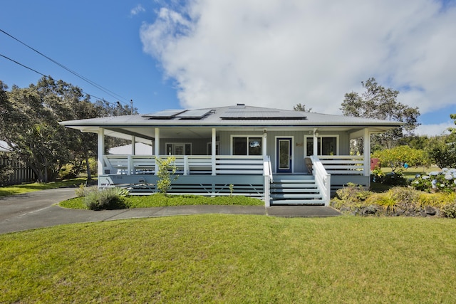 99-1808 Kilau Way, Volcano, HI 96785 - farmhouse-style home featuring covered porch, a front yard, and roof mounted solar panels