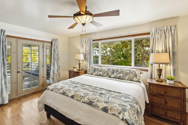 99-1808 Kilau Way, Volcano, HI 96785 - bedroom with access to exterior, wood finished floors, and a ceiling fan