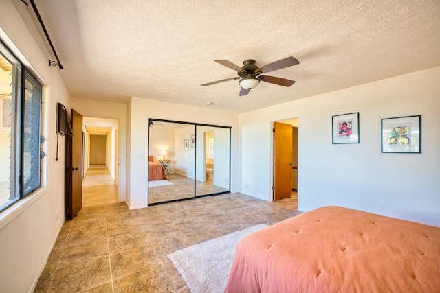 708 Kukuau St, Hilo, HI 96720 - bedroom with a textured ceiling, a closet, and ceiling fan