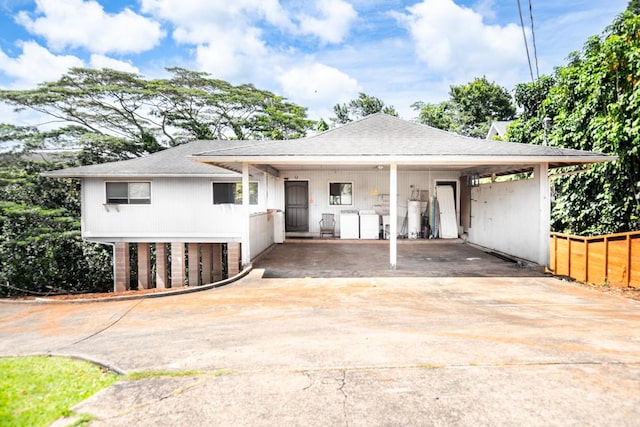 3351 Kalua Moa Rd, Koloa, HI 96756 - view of front of house featuring an attached carport, concrete driveway, and roof with shingles