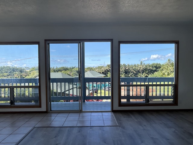 4666 Hauaala Rd Unit 1, Kapaa, HI 96746 - doorway to outside with wood finished floors and a textured ceiling