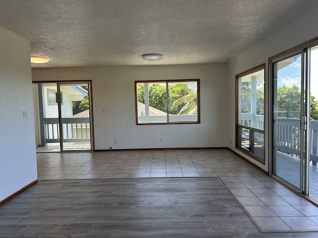 4666 Hauaala Rd Unit 1, Kapaa, HI 96746 - unfurnished room featuring wood finished floors, a textured ceiling, and baseboards