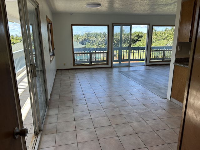 4666 Hauaala Rd Unit 1, Kapaa, HI 96746 - unfurnished room featuring light tile patterned flooring, a textured ceiling, and baseboards
