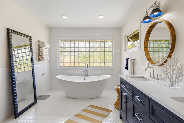 3764 Kakela Makai Dr, Kalaheo, HI 96741 - bathroom featuring double vanity, healthy amount of natural light, a soaking tub, tile walls, and tile patterned flooring
