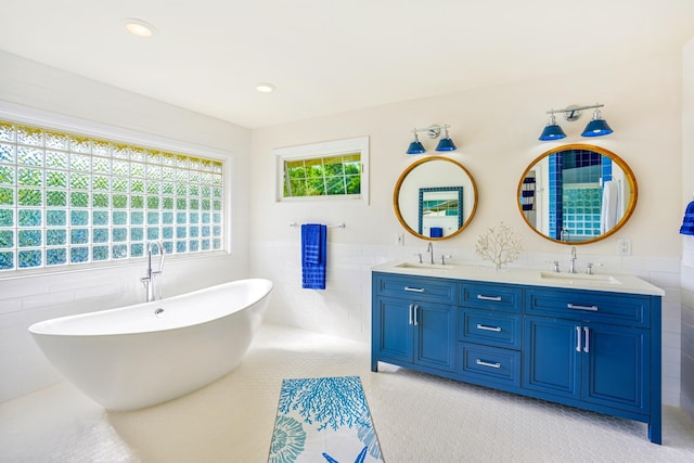3764 Kakela Makai Dr, Kalaheo, HI 96741 - bathroom with tile walls, double vanity, a freestanding tub, wainscoting, and recessed lighting