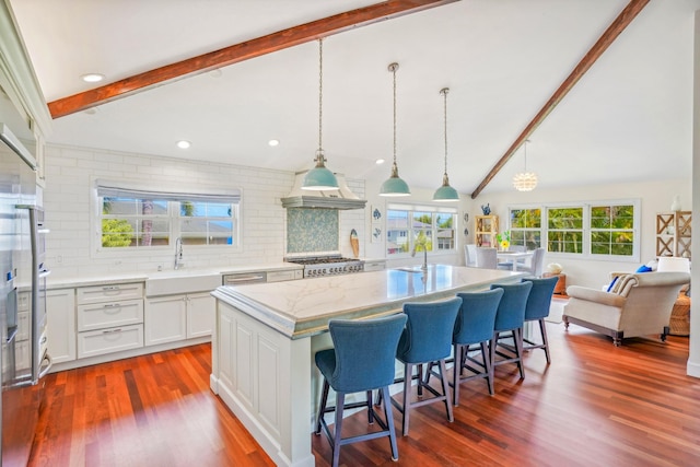 3764 Kakela Makai Dr, Kalaheo, HI 96741 - kitchen with a sink, backsplash, a kitchen bar, white cabinetry, and dark wood-type flooring