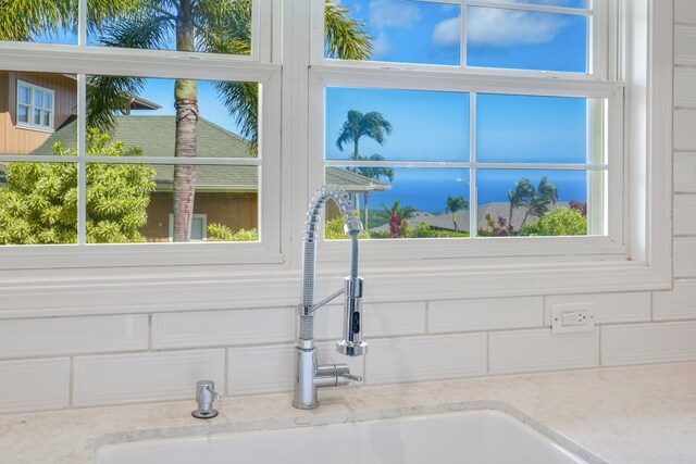 3764 Kakela Makai Dr, Kalaheo, HI 96741 - kitchen view of a sink, tasteful backsplash, and light stone countertops