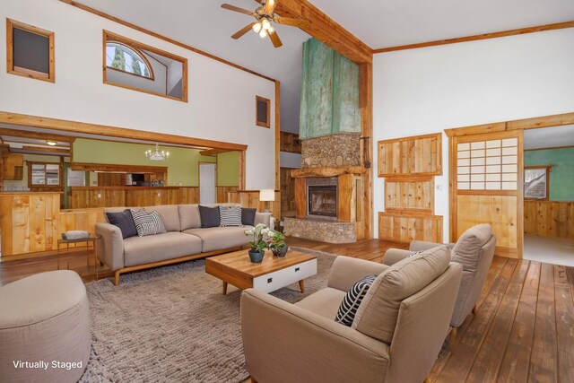 66-1665-A Kawaihae Rd, Kamuela, HI 96743 - living room featuring wood-type flooring, a towering ceiling, a large fireplace, ceiling fan, and wood walls