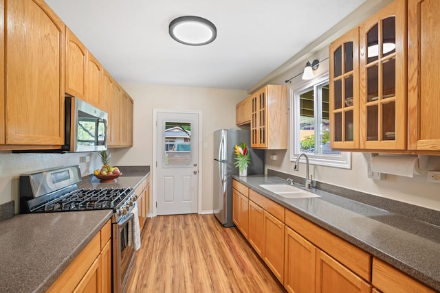 5045 Menehune Rd, Waimea, HI 96796 - kitchen with appliances with stainless steel finishes, light wood finished floors, healthy amount of natural light, and glass insert cabinets