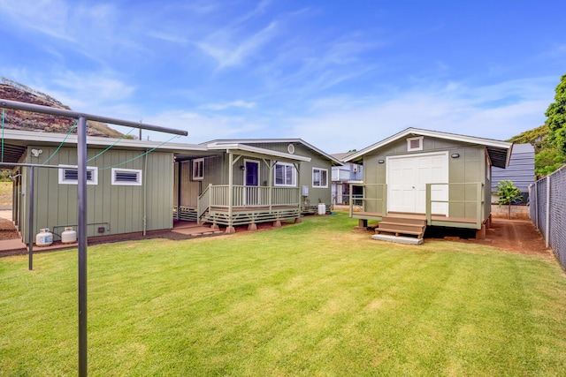 5045 Menehune Rd, Waimea, HI 96796 - rear view of house featuring a wooden deck and a storage shed