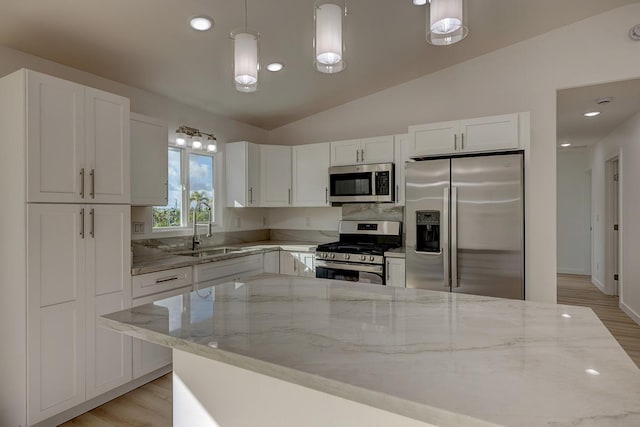 16-2075 Lilikoi Dr, Pahoa, HI 96778 - kitchen with stainless steel appliances, white cabinets, light stone countertops, light wood-style flooring, and lofted ceiling